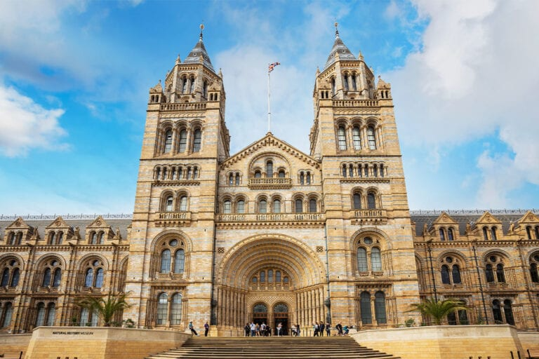 Exterior view of the Natural History Museum in London, featuring its grand entrance and detailed facade